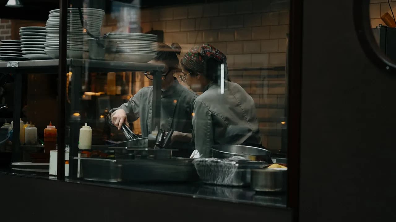 Candid shot of chefs cooking in a restaurant kitchen in Amsterdam.