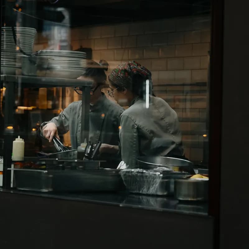 Candid shot of chefs cooking in a restaurant kitchen in Amsterdam.