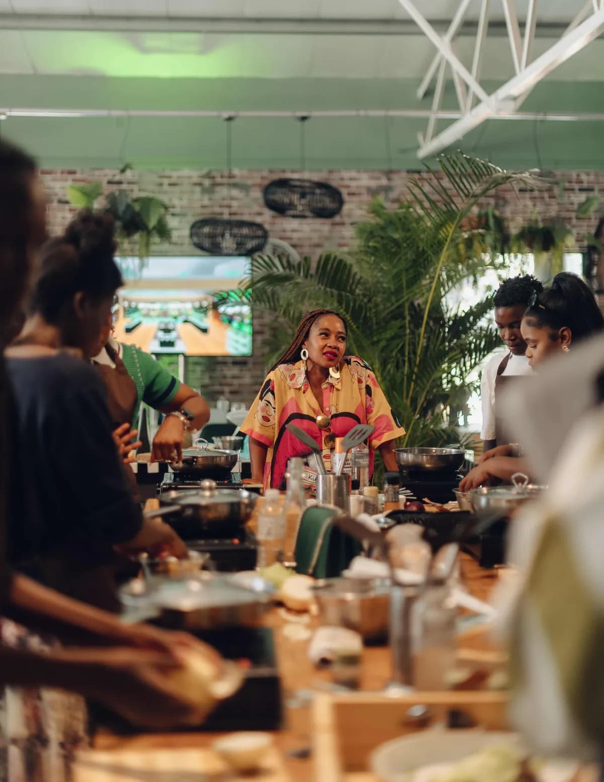 Group of guests cooking together during an interactive Good Food Studio cooking class.