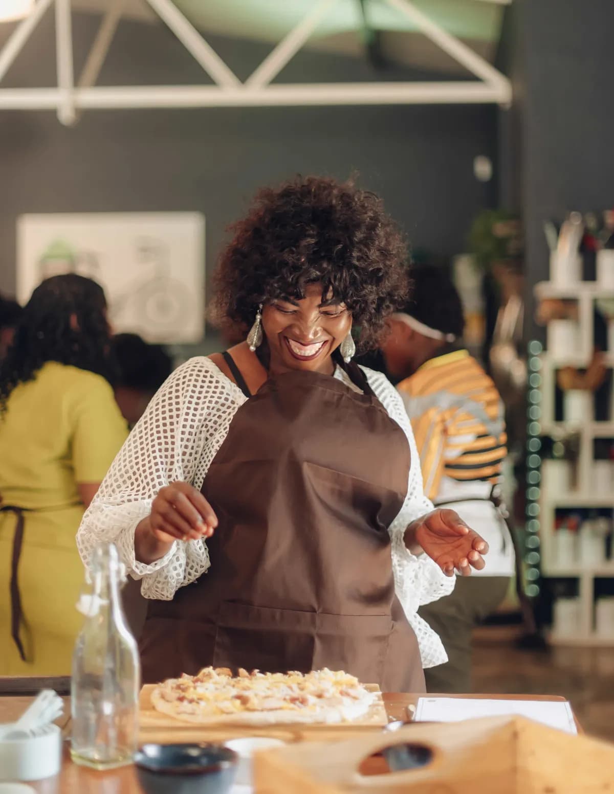 Guest laughing while cooking during a Good Food Studio cooking class.