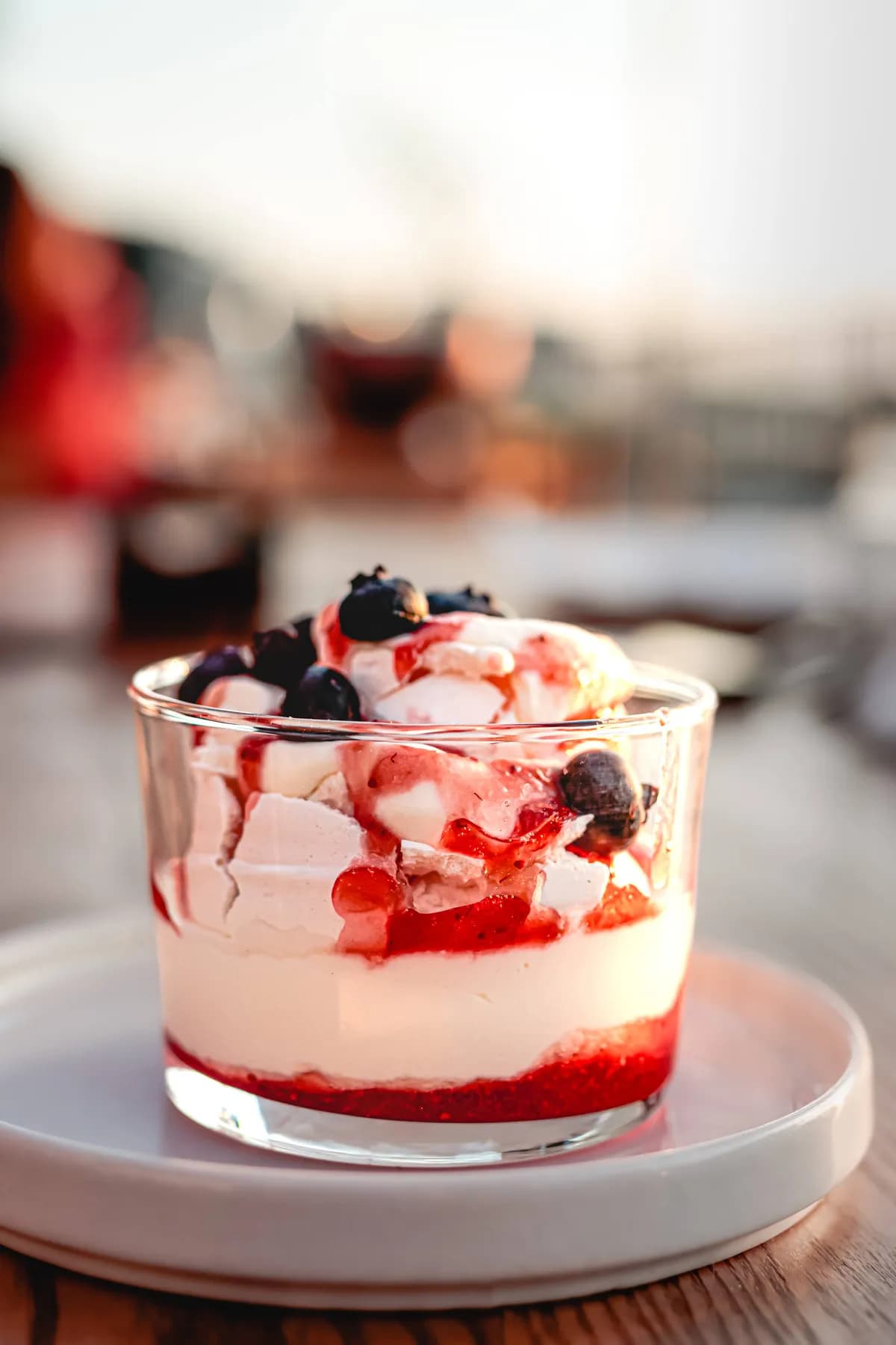 Dessert served in a glass and photographed outdoors.