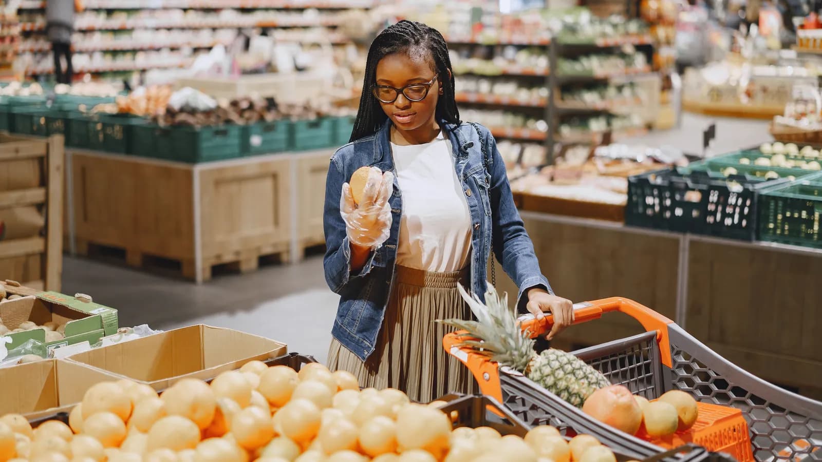 Woman grocery shopping and looking at the cost of food