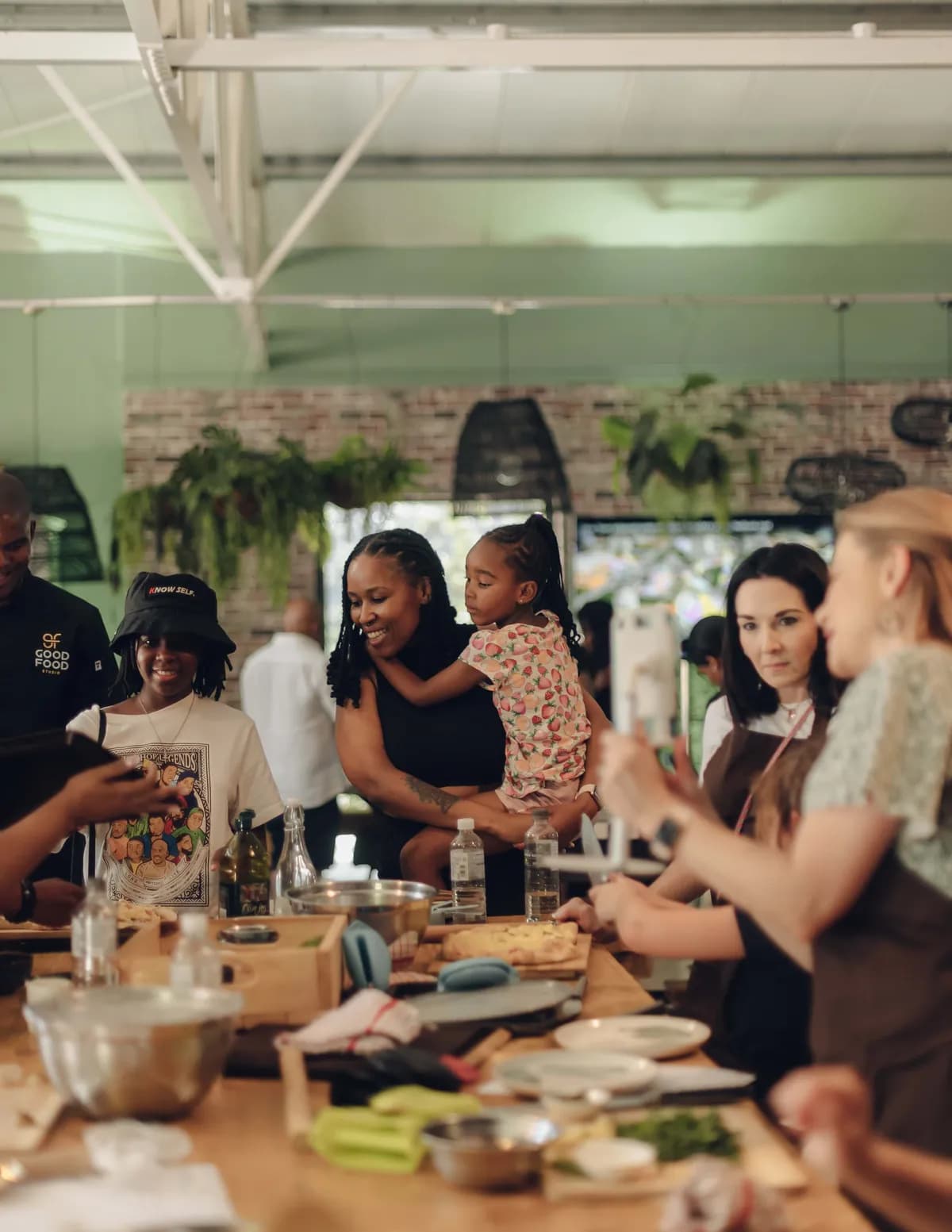 Guests standing together during an interactive cooking class at Good Food Studio.